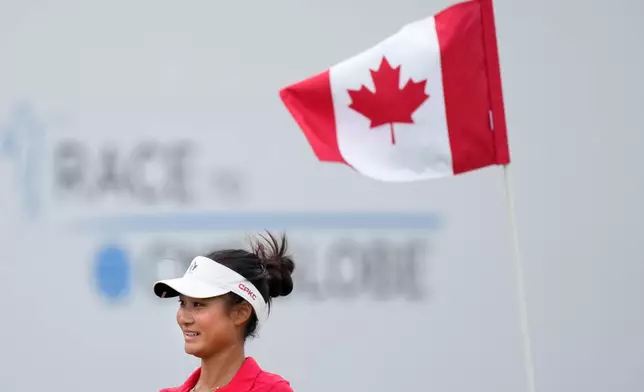 Aphrodite Deng, of Canada, smiles after making birdie on the 18th hole during the final round at the LPGA Canadian Women's Open golf tournament in Edmonton, Alberta, Sunday, Aug. 23, 2026. (Darryl Dyck/The Canadian Press via AP)