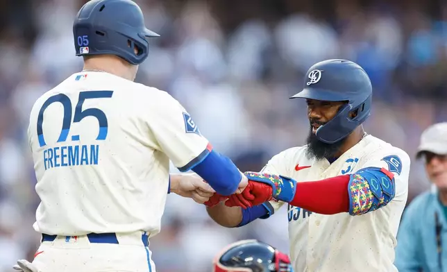 Los Angeles Dodgers' Teoscar Hernandez (37) is greeted by Los Angeles Dodgers' Freddie Freeman (5) after hitting a two-run home run during the second inning of a baseball game against the Boston Red Sox, Saturday, Aug. 1, 2026, in Los Angeles. (AP Photo/Caroline Brehman)