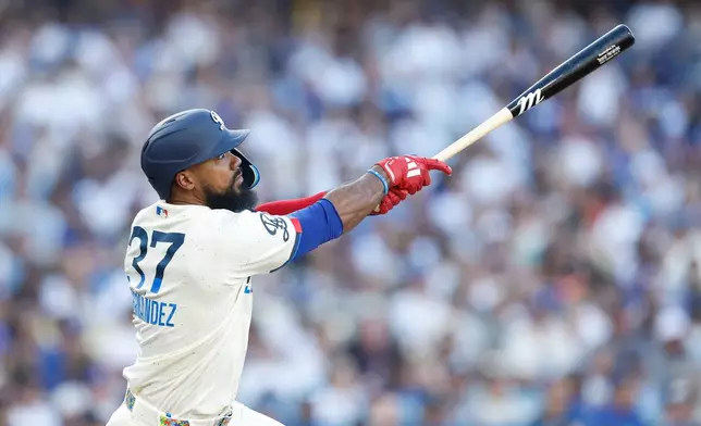 Los Angeles Dodgers' Teoscar Hernandez (37) watches the ball as he hits a two-run home run during the second inning of a baseball game against the Boston Red Sox, Saturday, Aug. 1, 2026, in Los Angeles. (AP Photo/Caroline Brehman)