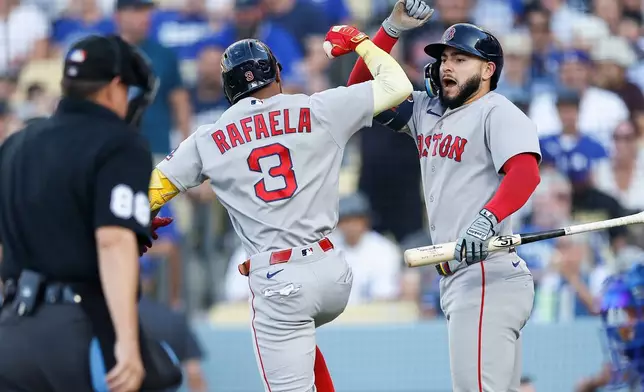 Boston Red Sox's Ceddanne Rafaela (3), left, is greeted by Boston Red Sox's Wilyer Abreu (52) after hitting a solo home run during the first inning of a baseball game against the Los Angeles Dodgers, Saturday, Aug. 1, 2026, in Los Angeles. (AP Photo/Caroline Brehman)