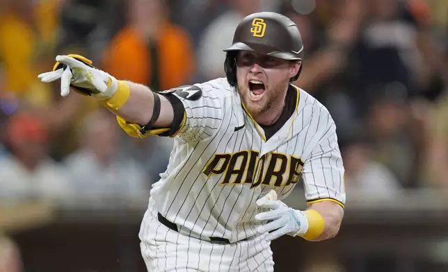 San Diego Padres' Jake Cronenworth celebrates after hitting a walk off single during the ninth inning as the Padres defeated the San Francisco Giants 6-5 in a baseball game Saturday, Aug. 1, 2026, in San Diego. (AP Photo/Gregory Bull)