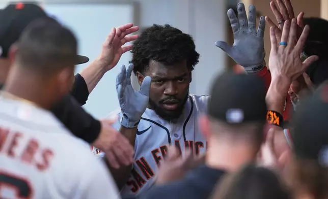 San Francisco Giants' Osleivis Basabe celebrates with teammates after hitting a two-run home run during the third inning of a baseball game against the San Diego Padres Saturday, Aug. 1, 2026, in San Diego. (AP Photo/Gregory Bull)