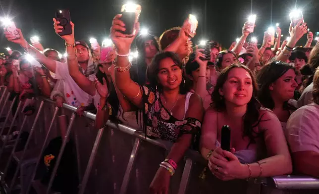 Audience members watch Olivia Rodrigo perform with special guest Sarah McLachlan at the Daisy Chain Fields Music Festival on Saturday, Aug. 29, 2026, at Great Park in Irvine, Calif. (AP Photo/Chris Pizzello)