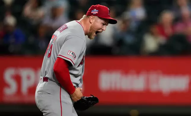 Los Angeles Angels pitcher Ryan Watson celebrates after striking out Texas Rangers' Evan Carter in the ninth inning of a baseball game Friday, Aug. 21, 2026, in Arlington, Texas. (AP Photo/Tony Gutierrez)