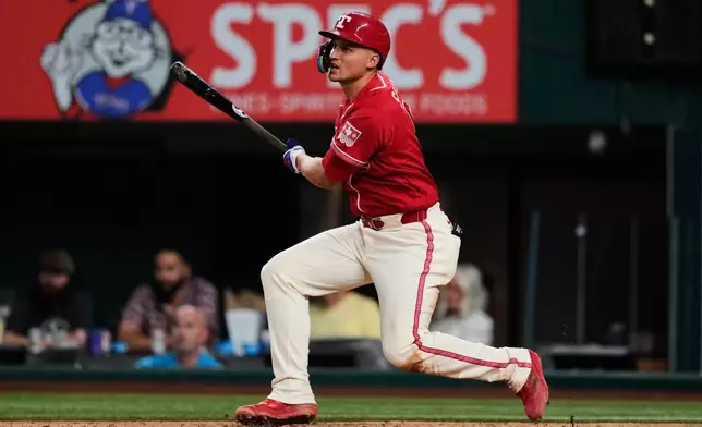 Texas Rangers' Corey Seager singles in the eighth inning of a baseball game against the Los Angeles Angels Friday, Aug. 21, 2026, in Arlington, Texas. (AP Photo/Tony Gutierrez)