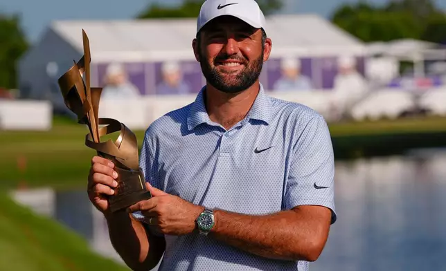 Scottie Scheffler holds the winning trophy after the final round of the St. Jude Championship golf tournament, Sunday, Aug. 16, 2026, in Memphis, Tenn. (AP Photo/George Walker IV)