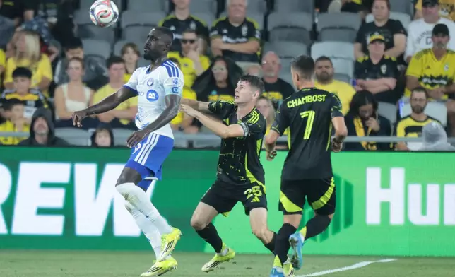 CF Montreal forward Prince Owusu, left, works for the ball in front of Columbus Crew midfielder Sean Zawadzki, center, and midfielder Dylan Chambost during the first of an MLS soccer match in Columbus, Ohio, Wednesday, Aug. 19, 2026. (AP Photo/Paul Vernon)
