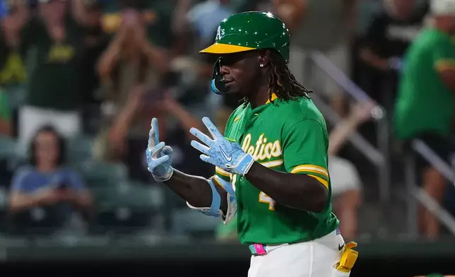 Athletics' Lawrence Butler (4) reacts after hitting a home run in the seventh inning during a baseball game against the Minnesota Twins Wednesday, Aug. 26, 2026, in West Sacramento, Calif. (AP Photo/Alan Greth)