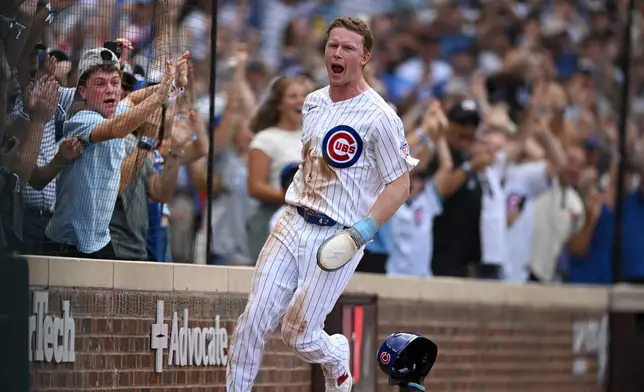 Chicago Cubs' Pete Crow-Armstrong celebrates after scoring the winning run on a throwing error by Toronto Blue Jays catcher Brandon Valenzuela during the eleventh inning of a baseball game in Chicago, Thursday, Aug. 6, 2026. (AP Photo/Paul Beaty)