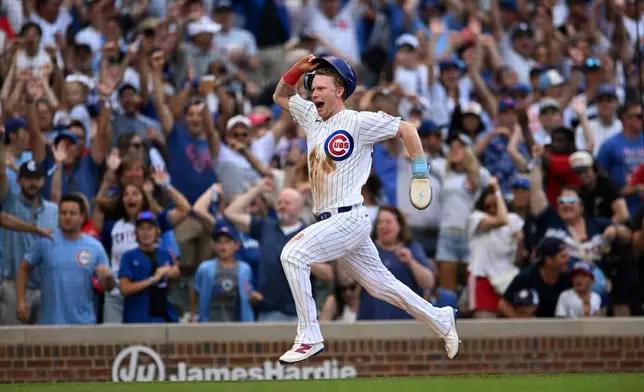 Chicago Cubs' Pete Crow-Armstrong celebrates while scoring the winning run on a throwing error by Toronto Blue Jays catcher Brandon Valenzuela during the eleventh inning of a baseball game in Chicago, Thursday, Aug. 6, 2026. (AP Photo/Paul Beaty)