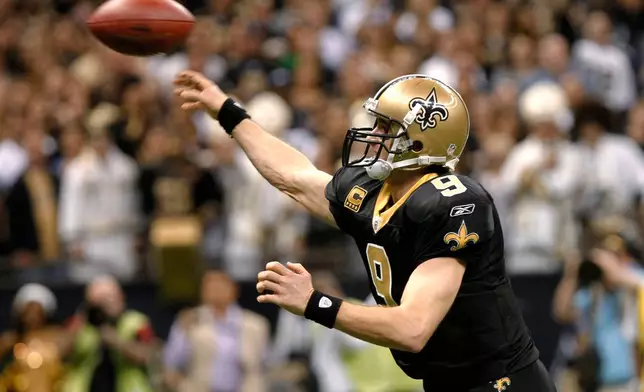 FILE - New Orleans Saints quarterback Drew Brees throws a touchdown pass during the fourth quarter of an NFL football game against the Atlanta Falcons in New Orleans, Dec. 26, 2011. (AP Photo/Rusty Costanza, File)