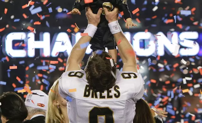FILE - New Orleans Saints quarterback Drew Brees (9) holds his son, Baylen, after the NFL Super Bowl XLIV football game against the Indianapolis Colts in Miami on Feb. 7, 2010. (AP Photo/Eric Gay, File)