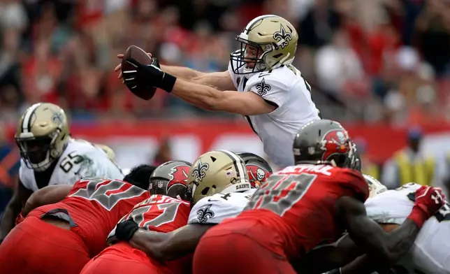 FILE - New Orleans Saints quarterback Drew Brees dives over the line against the Tampa Bay Buccaneers to score on a one-yard touchdown run during the second half of an NFL football game, Dec. 9, 2018, in Tampa, Fla. (AP Photo/Jason Behnken, File)