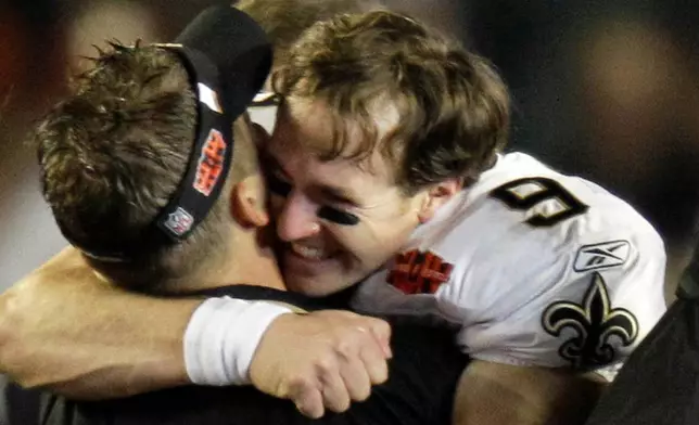 FILE - New Orleans Saints quarterback Drew Brees (9) hugs head coach Sean Payton after the Saints won the NFL Super Bowl XLIV football game in Miami, Feb. 7, 2010. (AP Photo/Chuck Burton, File)