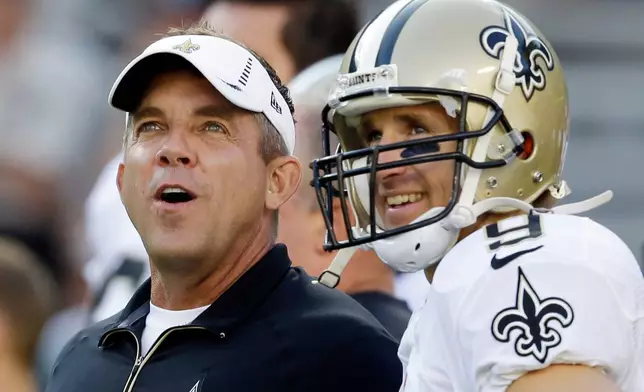 FILE - New Orleans Saints head coach Sean Payton talks to quarterback Drew Brees before a preseason NFL football game against the Green Bay Packers, Sept. 3, 2015, in Green Bay, Wis. (AP Photo/Jeffrey Phelps, File)