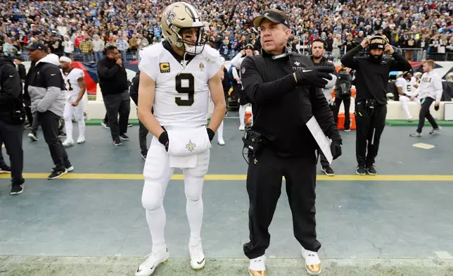 FILE - New Orleans Saints quarterback Drew Brees (9) and head coach Sean Payton wait for the start of an NFL football game against the Tennessee Titans, Dec. 22, 2019, in Nashville, Tenn. (AP Photo/Mark Zaleski, File)