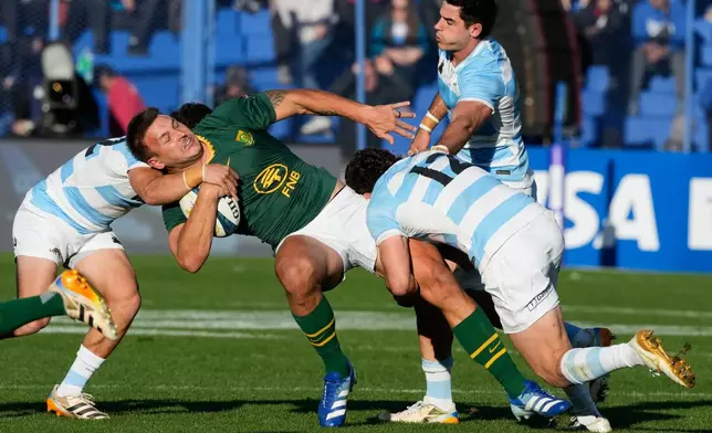 South Africa Andre Esterhuizen, center, is tackled by Argentina's Faustino Sanchez Valarolo (12) and Agustin Moyano during a rugby test match in Buenos Aires, Argentina, Saturday, Aug. 8, 2026. (AP Photo/Gustavo Garello)