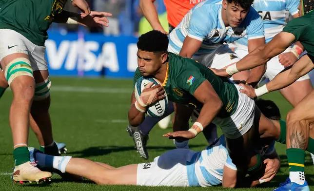South Africa Sacha Feinberg-Mngomezulu, center, is tackled by Argentina's Geronimo Prisciantelli during a rugby test match in Buenos Aires, Argentina, Saturday, Aug. 8, 2026. (AP Photo/Gustavo Garello)