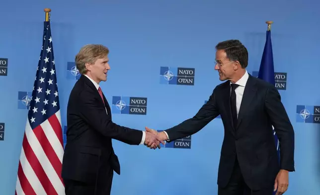 NATO Secretary General Mark Rutte, right, greets United States Undersecretary of Defense Elbridge Colby prior to a meeting at NATO headquarters in Brussels, Thursday, Aug. 27, 2026. (AP Photo/Virginia Mayo)