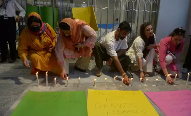 People light candles in the memory of the newborn victims outside the Mother and Child Health ward at the Pakistan Institute of Medical Sciences, in Islamabad, Pakistan, Thursday, Aug. 27, 2026. (AP Photo/M.A. Sheik)