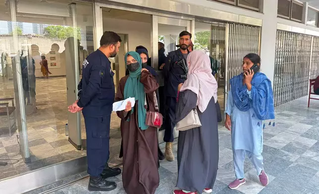 Women leave the Mother and Child Health ward at a hospital, in Islamabad, Pakistan, Thursday, Aug. 27, 2026. (AP Photo/M. Yousaf)