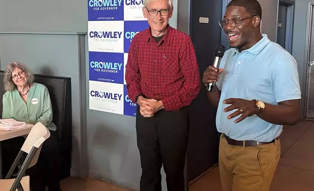 Wisconsin Gov. Tony Evers, center, campaigns with Democratic candidate for Governor David Crowley, right, Monday, Aug. 10, 2026, in Madison, Wis. (AP Photo/Scott Bauer)