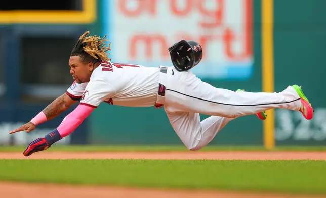 Cleveland Guardians' Jose Ramirez dives but is caught while trying to steal second base during the first inning of a baseball game against the San Diego Padres in Cleveland, Sunday, Aug. 16, 2026. (AP Photo/Tim Phillis)