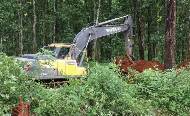 An earthmover digs a burial site for a mass burial of flash floods victims, in Chitwan, Nepal, Saturday, Aug. 29, 2026. (AP Photo/Nisha Shrestha)