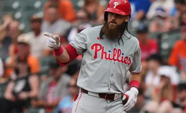 Philadelphia Phillies' Brandon Marsh reacts after J.T. Realmuto draws a walk against Baltimore Orioles pitcher Anthony Nunez to advance the runners on base during the fourth inning of a baseball game, Sunday, Aug. 2, 2026, in Baltimore. (AP Photo/Stephanie Scarbrough)