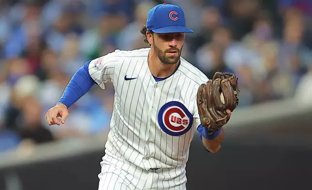 Chicago Cubs' Dansby Swanson fields the ball hit by New York Yankees' Amed Rosario during the fourth inning of a baseball game, Saturday, Aug. 1, 2026, in Chicago. (AP Photo/Melissa Tamez)