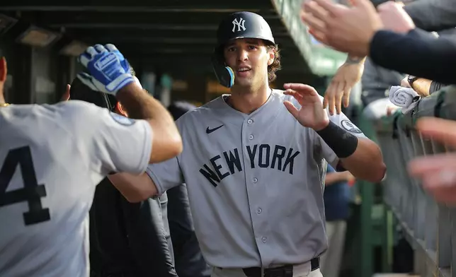 New York Yankees' Spencer Jones celebrates in the dugout after scoring on teammate José Caballero's RBI single during the fifth inning of a baseball game against the Chicago Cubs, Saturday, Aug. 1, 2026, in Chicago. (AP Photo/Melissa Tamez)