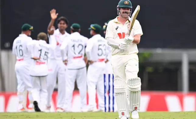 Australia's Travis Head, right, walks off as Bangladesh players celebrates his wicket during their cricket test match in Darwin, Australia, Thursday, Aug. 13, 2026. (James Ross/AAP Image via AP)