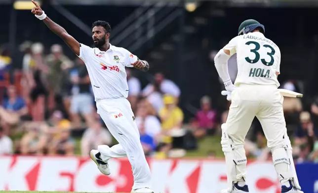 Bangladesh's Ebadot Hossain, left, celebrates the dismissal of Marnus Labuschagne from Australia during their cricket test match in Darwin, Australia, Thursday, Aug. 13, 2026. (James Ross/AAP Image via AP)