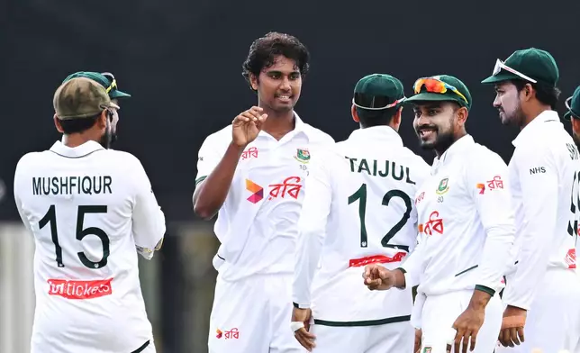 Bangladesh's Hasan Mahmud, second left, celebrates with teammates after taking the wicket of Australia's Travis Head during their cricket test match in Darwin, Australia, Thursday, Aug. 13, 2026. (James Ross/AAP Image via AP)