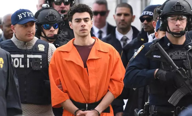 FILE - Luigi Mangione, a suspect in the fatal shooting of UnitedHealthcare CEO Brian Thompson, is escorted by police, Thursday, Dec. 19, 2024, in New York. (AP Photo/Pamela Smith, File)