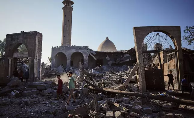 Palestinians inspect the Abu Salim Mosque a day after it was hit by an Israeli airstrike, in Deir al-Balah, central Gaza Strip, Tuesday, Aug. 25, 2026. (AP Photo/Abdel Kareem Hana)