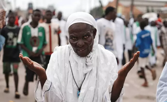A Muslim faithful prays as she marches in Lagos, Nigeria, to mark Prophet Muhammad's birthday, known as Mawlid, Tuesday, Aug. 25, 2026. (AP Photo/Sunday Alamba)
