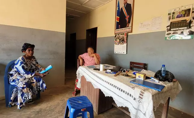 Parents who came for their children's school resumption sit inside an office of a school in Ituri province, eastern Congo, Thursday, Aug. 27, 2026. (AP Photo/Constant Same Bagalwa)
