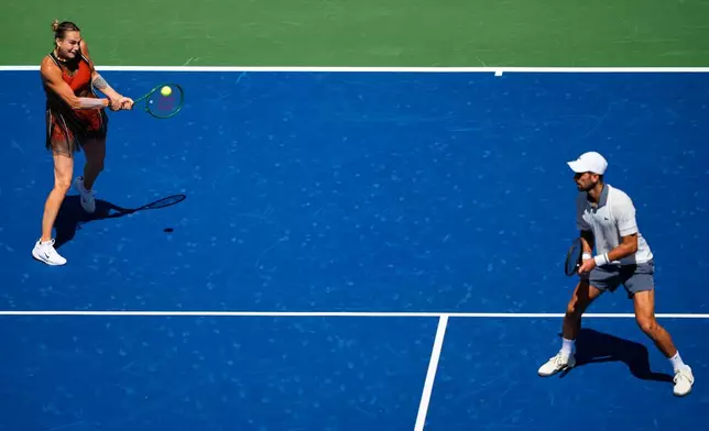 Aryna Sabalenka, of Belarus, and Novak Djokovic, of Serbia, during a mixed doubles match at the U.S. Open tennis championships, Tuesday, Aug. 25, 2026, in New York. (AP Photo/Yuki Iwamura)