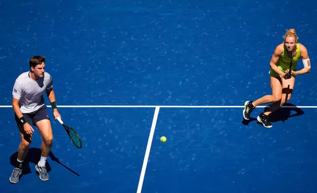 Henry Patten, of Britain, left, and Katerina Siniakova, of the Czech Republic, during a mixed doubles match at the U.S. Open tennis championships, Tuesday, Aug. 25, 2026, in New York. (AP Photo/Yuki Iwamura)