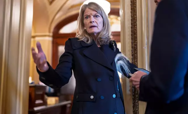 FILE - Sen. Lisa Murkowski, R-Alaska, a member of the Senate Appropriations Committee, pauses outside the chamber to answer a question from a reporter at the Capitol in Washington, March 14, 2025. (AP Photo/J. Scott Applewhite, File)