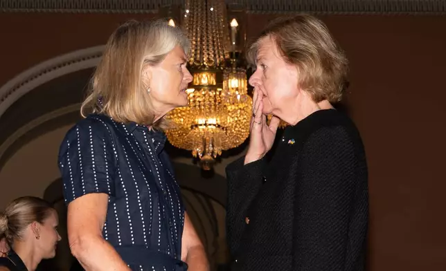 Sen. Lisa Murkowski, R-Alaksa, talks with Sen. Tammy Baldwin, D-Wis., at the U.S. Capitol, Tuesday, July 28, 2026, in Washington. (AP Photo/Allison Robbert)