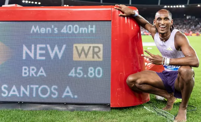 Brazil's Alison dos Santos celebrates after winning the men's 400-meter hurdles, setting a new world record, at the Diamond League athletics meeting, Thursday, Aug. 27, 2026, in Zurich, Switzerland. (Claudio Thoma/Keystone via AP)