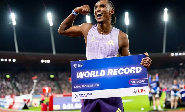 Brazil's Alison dos Santos celebrates winning the men's 400-meter hurdles, setting a new world record, at the Diamond League athletics meeting, Thursday, Aug. 27, 2026, in Zurich, Switzerland. (Jean-Christophe Bott/Keystone via AP)