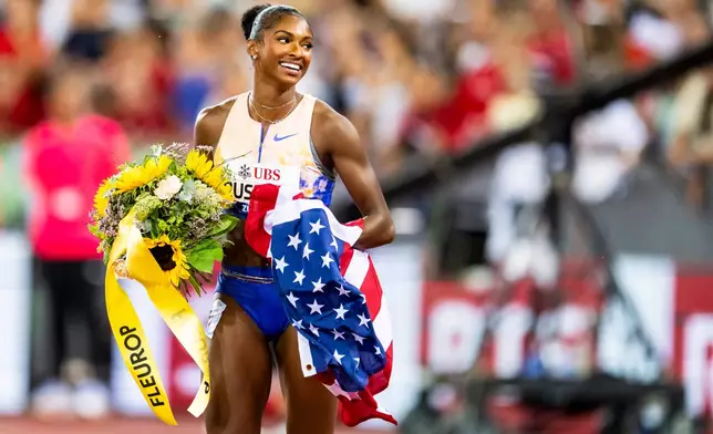 United States' Masai Russell celebrates after winning the women's 100-meter hurdles race, setting a new world record, at the Diamond League athletics meeting, Thursday, Aug. 27, 2026, in Zurich, Switzerland. (Jean-Christophe Bott/Keystone via AP)