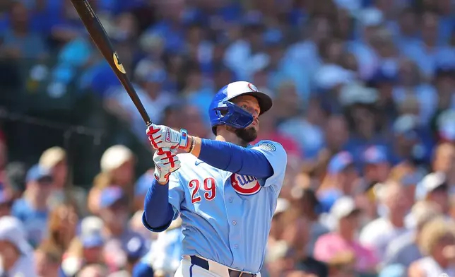 Chicago Cubs' Michael Busch watches his two-run home run during the third inning of a baseball game against the Cincinnati Reds, Friday, Aug. 28, 2026, in Chicago. (AP Photo/Melissa Tamez)