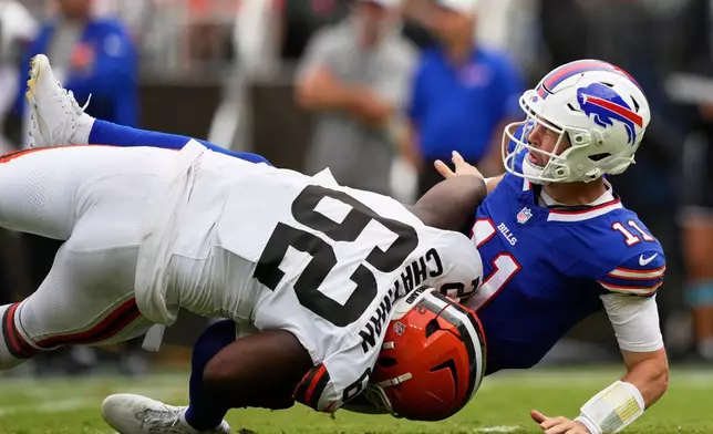 Buffalo Bills quarterback Kyle Allen (11) is tackled by Cleveland Browns defensive tackle Elijah Chatman (62) after passing during the first half of an NFL preseason football game, Saturday, Aug. 22, 2026, in Cleveland. (AP Photo/Carolyn Kaster)