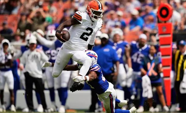 Cleveland Browns quarterback Shedeur Sanders (2) is tackled by Buffalo Bills cornerback Davison Igbinosun (21) during the first half of an NFL preseason football game, Saturday, Aug. 22, 2026, in Cleveland. (AP Photo/Carolyn Kaster)