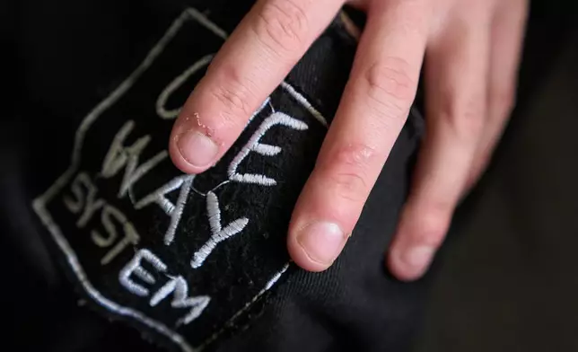Elijah Button, 21, shows a scar on his middle fingers caused by a knife wound that he was unable to seek medical help for, in St. Cloud, Fla., Thursday, Aug. 13, 2026. (AP Photo/Jacquelyn Martin)