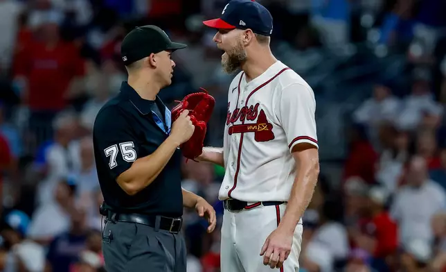 Atlanta Braves pitcher Chris Sale, right, speaks with umpire Edwin Jimenez (75) during a replay review in the ninth inning of a baseball game against the Los Angeles Dodgers, Thursday, Aug. 27, 2026, in Atlanta. (AP Photo/Erik S. Lesser)